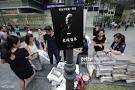 People queue up to puchase a one day special edition newspapers at.