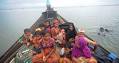Myanmar navy brings more than 200 migrants ashore after first boat.