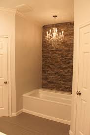 My tub with faux stone wall accent wall and chandelier. | Bathroom ...