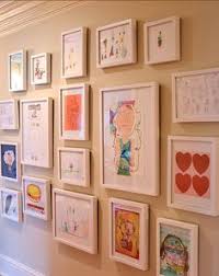 Kids art wall using cheap plastic frames that we used to change ...