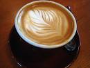 A latte poured by a barista at