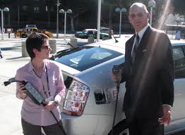 Toyota USA spokeswoman Cindy Knight and VP of Communications Irv Miller with a Prius converted by the company to a PHEV, at the LA Auto Show, November 2007. - toyota-knight-miller-full