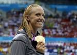 USA's Dana Vollmer poses with her gold medal after winning the 100 meter