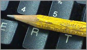 a computer with a pencil laying on it
