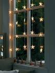 Christmas window decoration ideas with garlands, candles and displays