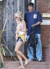 Benicio Del Toro is a hands on dad as he helps Kimberly Stewart