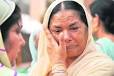 Surjit Kaur, widow of a policeman, wipes her tears on the Police ... - ldh3