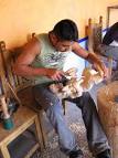 A cousin of Jacobo Angeles helps carve in the Mexican family's