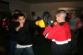 Above, Josh Hernandez (right) holds a mitt while another participant practices his jab, while below, younger kids ... - JoshMt