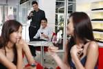 Men Flirting With Women Sitting At Another Table Royalty Free