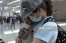 A mother and son from singapore wear masks as a precaution against.