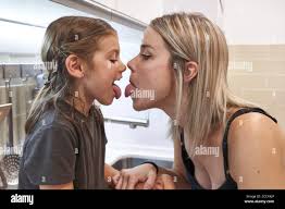 mother daughter tongue|Close Up Photo Beautiful Two People Brown Haired Mom Little Daughter  Friends Hipsters Silly Mouth Opened Tongue Out Fooling Around Playing Wear  White T-shirts Isolated Bright Blue Background. Stock Photo, Picture and