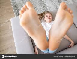 girl preteen soles|Smiling Young Girl Showing Feet on Camera, Isolated on Wooden Brown Stock  Photo - Alamy