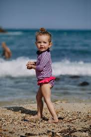 little girl bikini|Little girl in blue bikini sleeping on a tropical beach, her hair moving  with