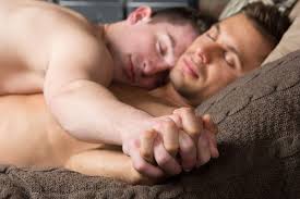 Man using his phone in bed next to sleeping partner jpg x Gay sleeping