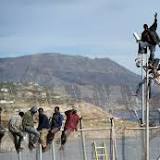 Migrants storm Spanish border fence in Morocco