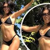 Kourtney Kardashian shows off her flawless figure in a bikini as she bounces on a trampoline: 'Burns the same calories ...