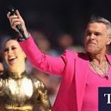 Robbie Williams rocks AFL grand final pre-match entertainment with Delta Goodrem and Shane Warne tribute
