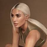 Kim Kardashian shows off teeny tiny waist in white lingerie and reveals hair makeover for new SKIMS ad