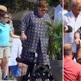 Elton John still standing as he walks hand-in-hand with son after wheelchair pictures worry fans